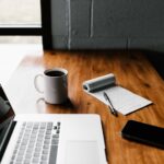 Writer planning a content strategy at a laptop with coffee